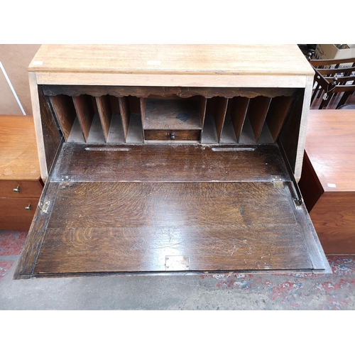 113 - An early 20th century oak geometric carved bureau with barley twist supports