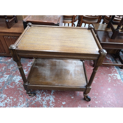 116 - Three pieces of oak furniture, two tea trolleys and one rectangular side table