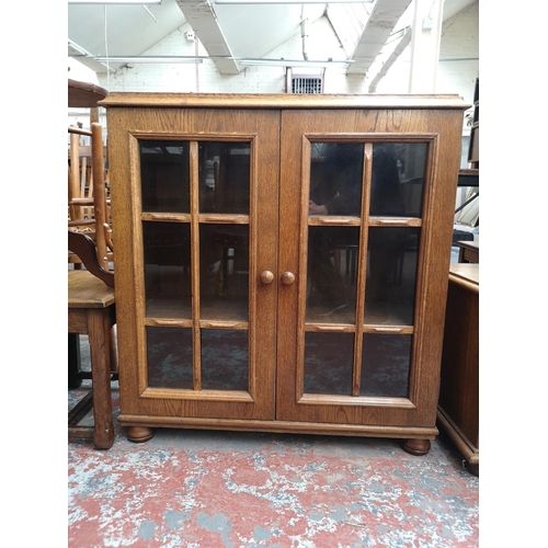 118 - Three pieces of oak furniture, two door glazed bookcase - approx. 90cm high x 85cm wide x 32cm deep,... 