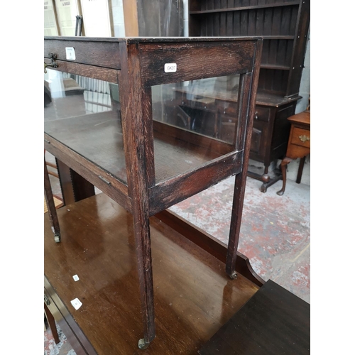 12 - An early 20th century oak and glass bijouterie table - approx. 70cm high x 59cm wide x 34cm deep