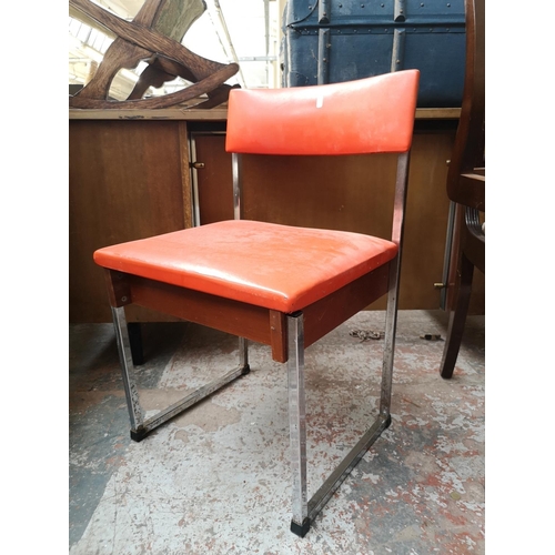 121 - A pair of 1970s orange vinyl and chrome plated dining chairs