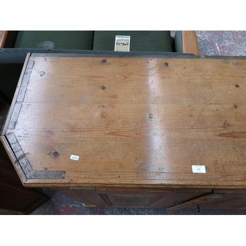 126 - A 19th century pine sideboard with two cupboard doors and three internal shelves - approx. 106cm hig... 