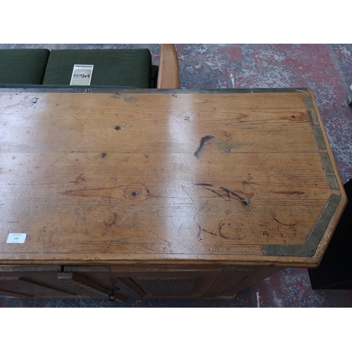 126 - A 19th century pine sideboard with two cupboard doors and three internal shelves - approx. 106cm hig... 