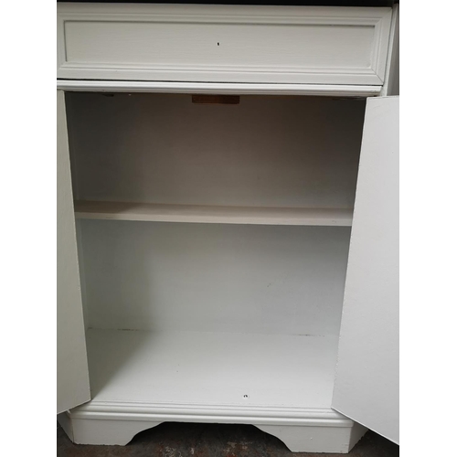 127 - Two pieces of furniture, one mahogany dressing table mirror and one white painted two door cabinet w... 