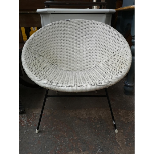 128 - A mid 20th century white plastic rattan effect and black tubular metal atomic bucket chair