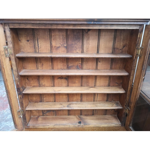 16 - A pine wall mountable display cabinet with two glazed doors - approx. 65cm high x 68cm wide x 13cm d... 