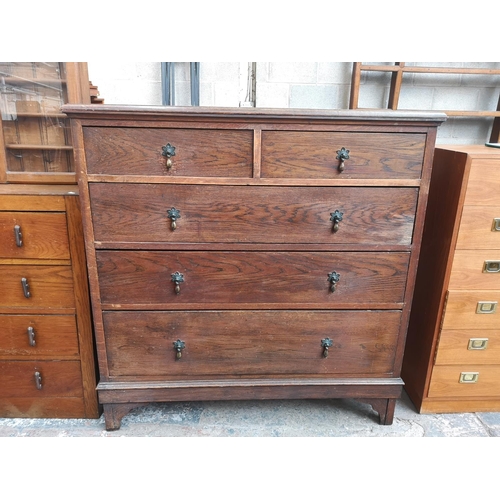 18 - An early/mid 20th century oak chest of two short over three long drawers - approx. 114cm high x 114c... 