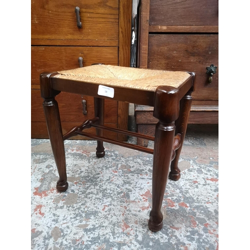 19 - An oak and rush seated stool - approx. 40cm high x 36cm wide x 28cm deep