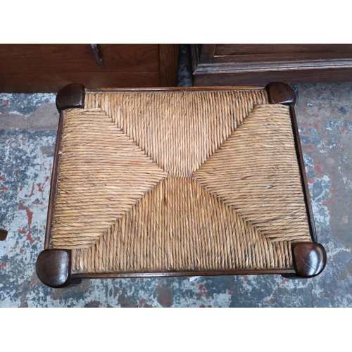 19 - An oak and rush seated stool - approx. 40cm high x 36cm wide x 28cm deep