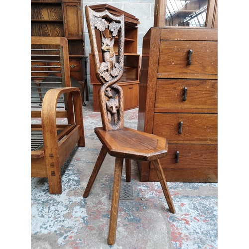 20 - A carved oak spinning chair with fox design - approx. 95cm high