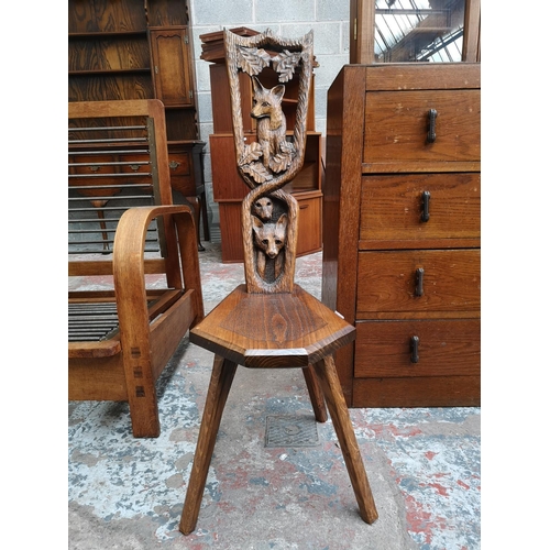 20 - A carved oak spinning chair with fox design - approx. 95cm high