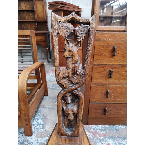 20 - A carved oak spinning chair with fox design - approx. 95cm high