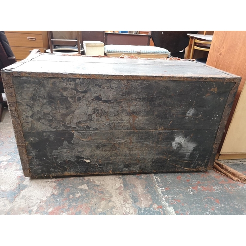 23 - An early 20th century pine travel trunk converted two door cabinet