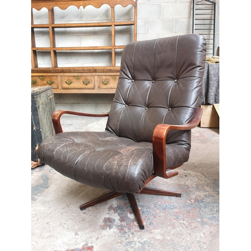 24 - A mid 20th century Swedish brown leather and bentwood swivel armchair with simulated rosewood metal ... 