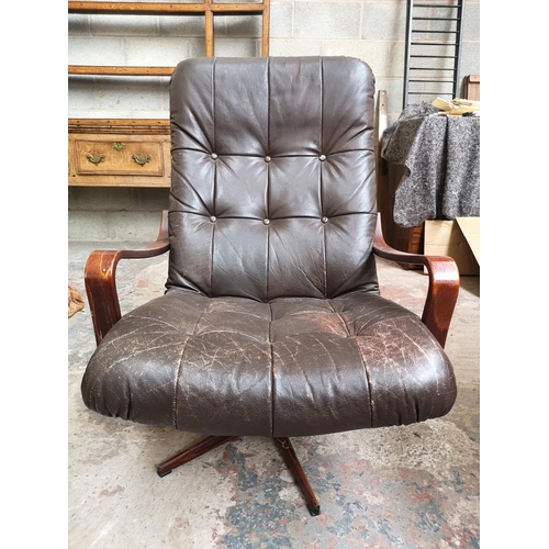 24 - A mid 20th century Swedish brown leather and bentwood swivel armchair with simulated rosewood metal ... 