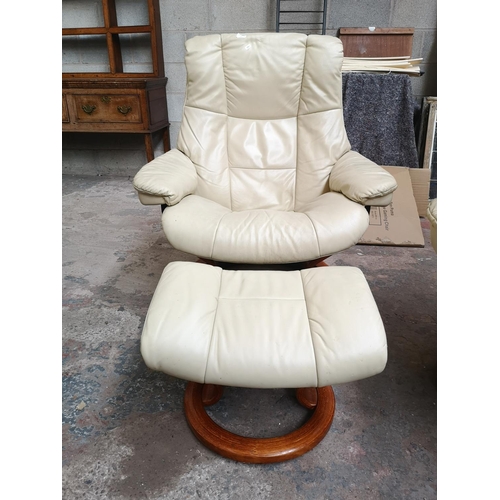 25 - An Ekornes Stressless cream leather swivel reclining armchair and footstool