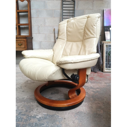 25 - An Ekornes Stressless cream leather swivel reclining armchair and footstool