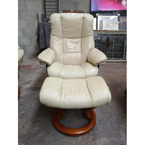 26 - An Ekornes Stressless cream leather swivel reclining armchair and footstool