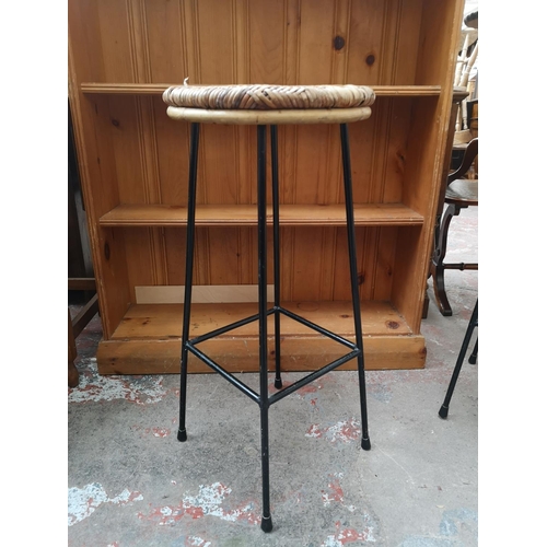 34 - Three mid 20th century wicker and black metal kitchen bar stools - approx. 74cm high x 33cm diameter