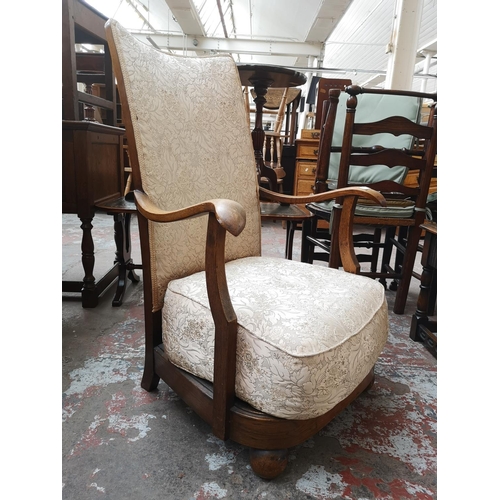 35 - A mid 20th century oak and floral upholstered armchair