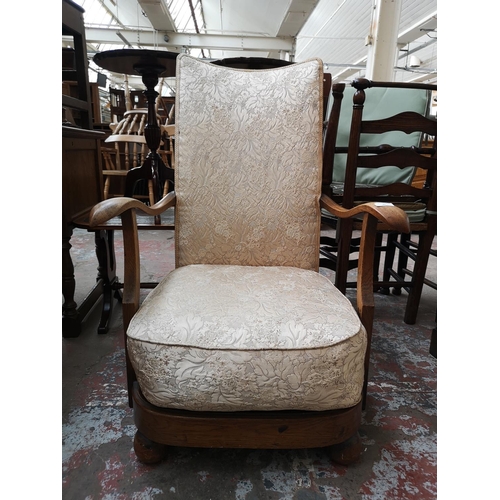 35 - A mid 20th century oak and floral upholstered armchair