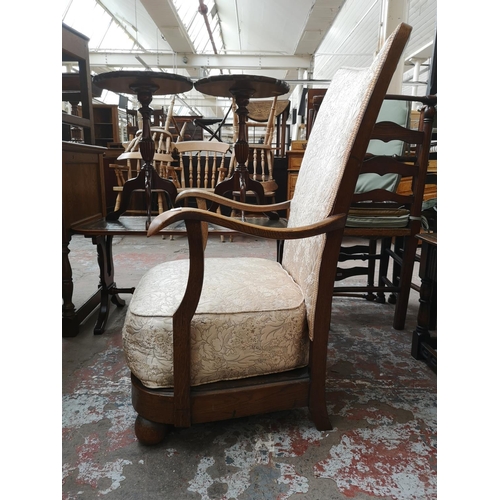 35 - A mid 20th century oak and floral upholstered armchair