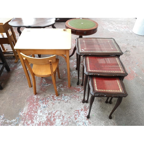 38 - Two piece of furniture, one beech child's desk and chair and one mahogany nest of three tables with ... 