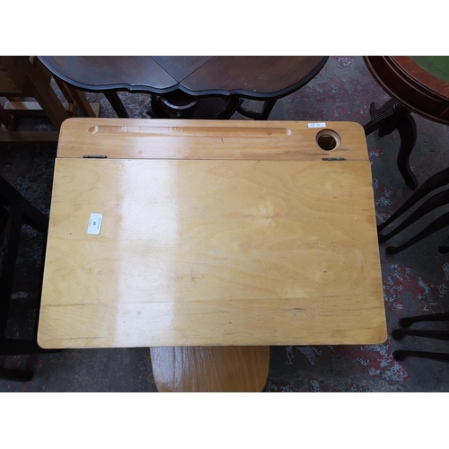 38 - Two piece of furniture, one beech child's desk and chair and one mahogany nest of three tables with ... 