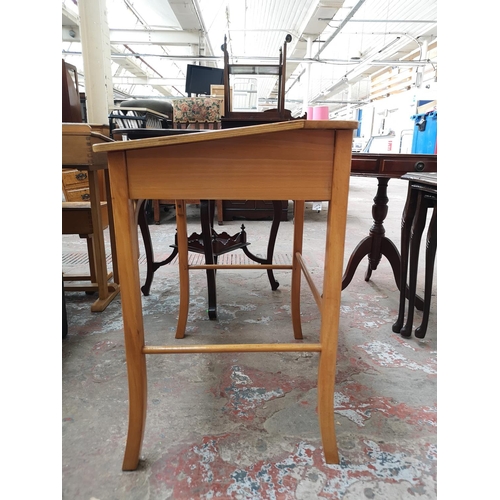 38 - Two piece of furniture, one beech child's desk and chair and one mahogany nest of three tables with ... 