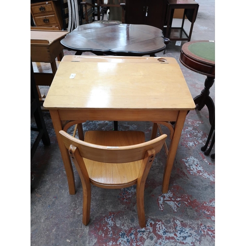 38 - Two piece of furniture, one beech child's desk and chair and one mahogany nest of three tables with ... 