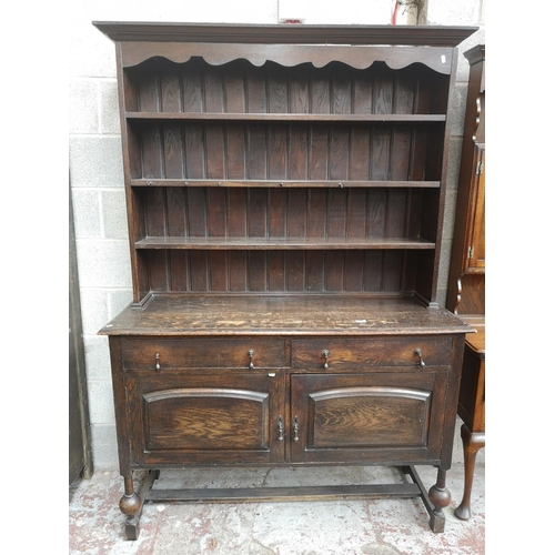 4 - A 1930s oak dresser with baluster supports - approx. 196cm high x 137cm wide x 48cm deep