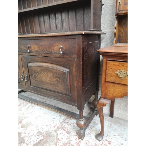 4 - A 1930s oak dresser with baluster supports - approx. 196cm high x 137cm wide x 48cm deep