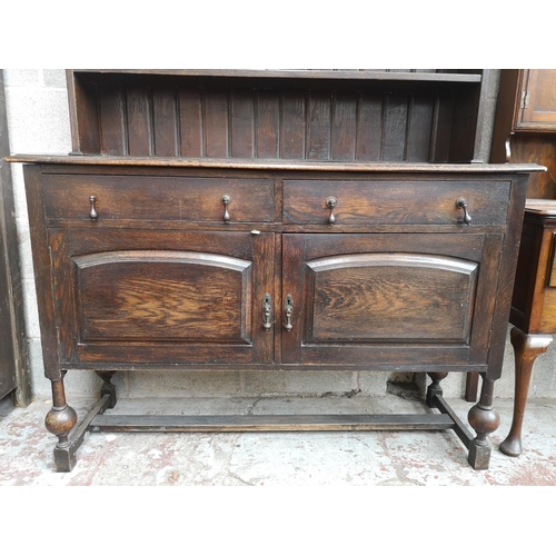 4 - A 1930s oak dresser with baluster supports - approx. 196cm high x 137cm wide x 48cm deep