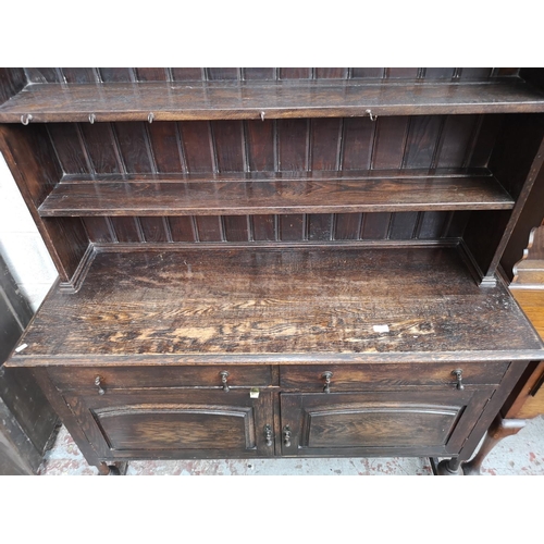 4 - A 1930s oak dresser with baluster supports - approx. 196cm high x 137cm wide x 48cm deep