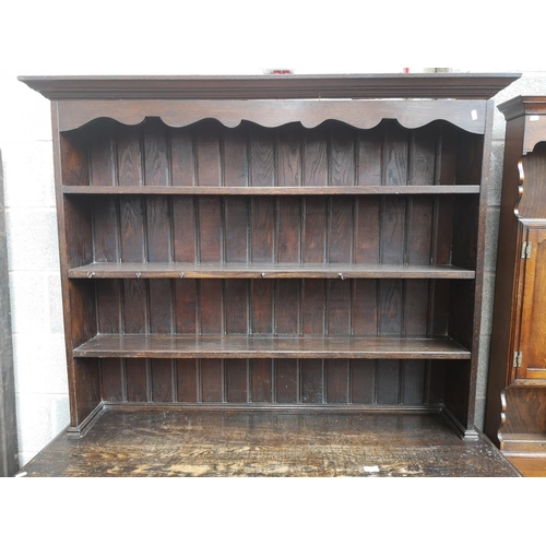 4 - A 1930s oak dresser with baluster supports - approx. 196cm high x 137cm wide x 48cm deep