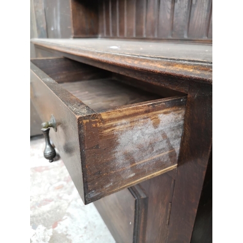 4 - A 1930s oak dresser with baluster supports - approx. 196cm high x 137cm wide x 48cm deep