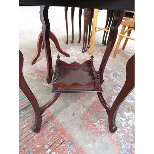 40 - An Edwardian mahogany quatrefoil folding two tier games table - approx. 69cm high x 45cm wide