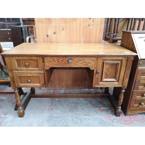 46 - An oak writing desk - approx. 75cm high x 120cm wide x 55cm deep