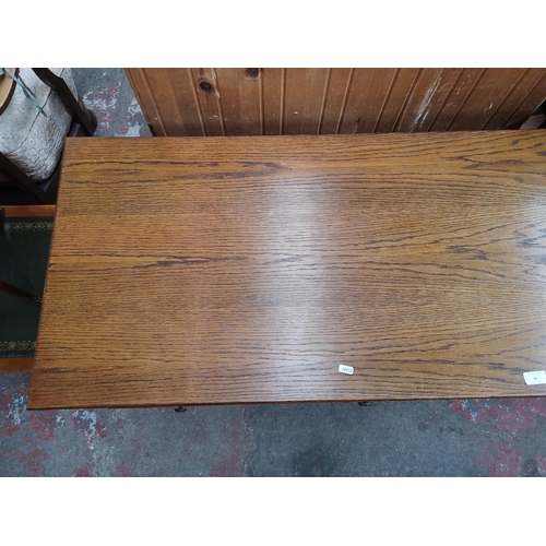 46 - An oak writing desk - approx. 75cm high x 120cm wide x 55cm deep