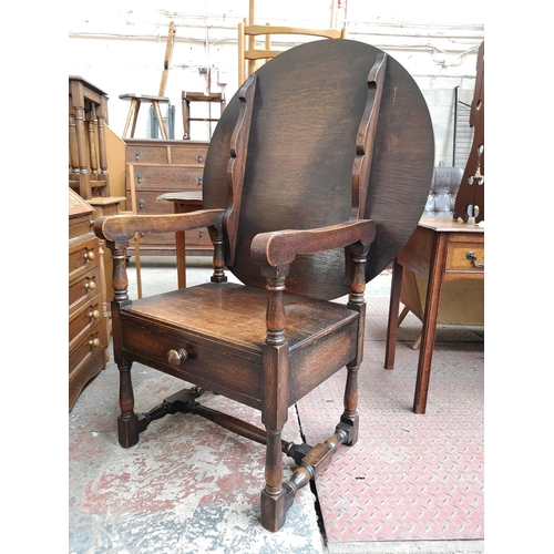 48 - A mid 20th century oak monk's seat - approx. 126cm high x 87cm wide x 60cm deep