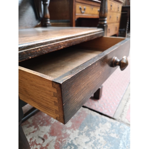 48 - A mid 20th century oak monk's seat - approx. 126cm high x 87cm wide x 60cm deep