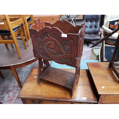 49 - A vintage carved oak magazine rack - approx. 67cm high x 40cm wide x 23cm deep