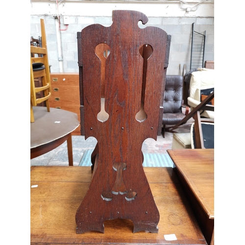 49 - A vintage carved oak magazine rack - approx. 67cm high x 40cm wide x 23cm deep