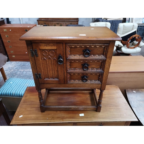 51 - A carved oak joint side cabinet with three drawers and single cupboard door - approx. 68cm high x 59... 