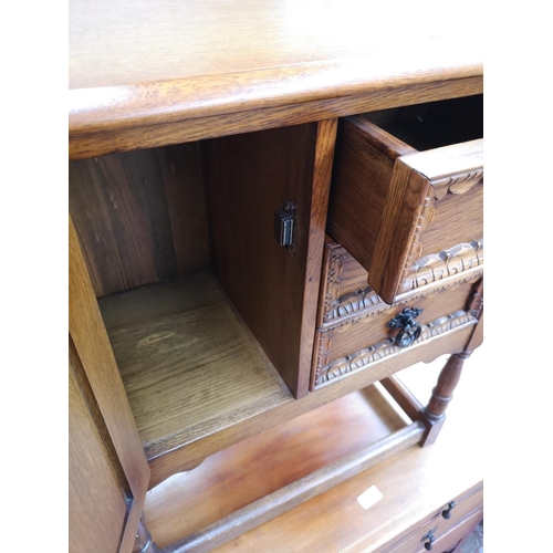 51 - A carved oak joint side cabinet with three drawers and single cupboard door - approx. 68cm high x 59... 