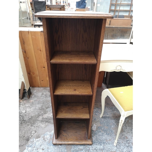 57 - An oak four tier free standing open bookcase - approx. 116cm high x 40cm wide x 25cm deep