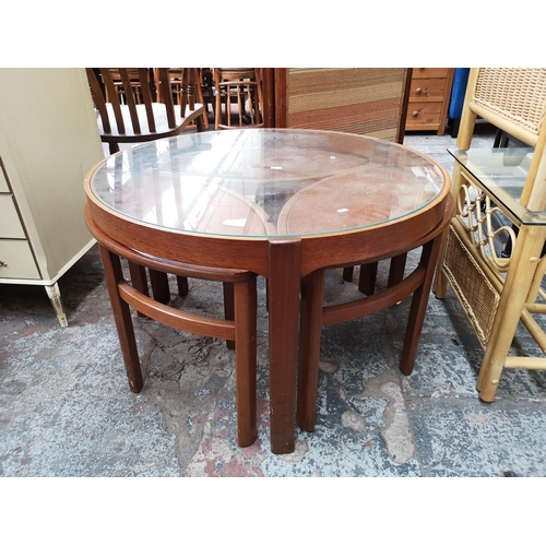 62 - A Nathan teak and glass Trinity coffee table with three nesting tables - approx. 51cm high x 81cm di... 