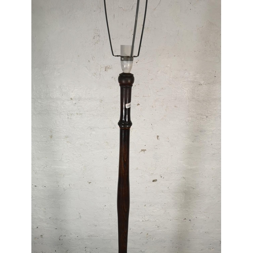 64 - A mid 20th century oak standard lamp - approx. 160cm high