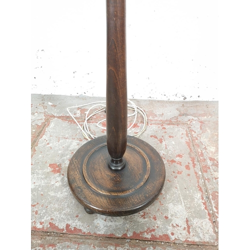 64 - A mid 20th century oak standard lamp - approx. 160cm high