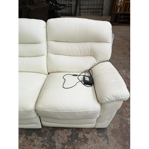 76 - A modern white leather electric reclining three seater sofa